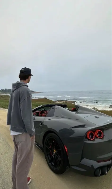 Brennan Harmatz beside a car on a coastal road
