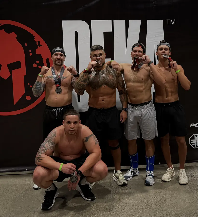 Brennan Harmatz and friends with medals after a DEKA fitness race