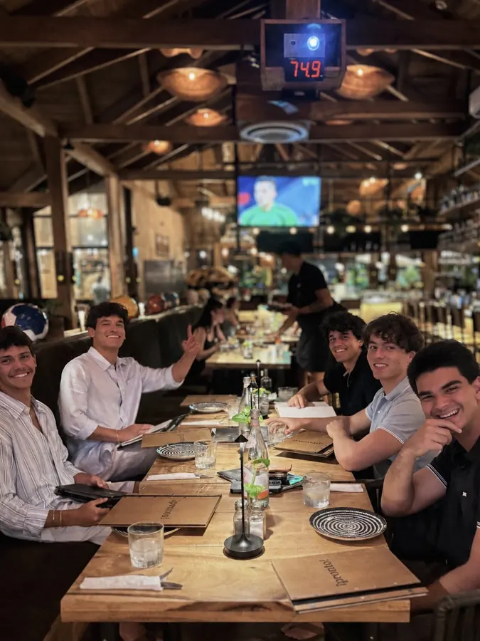 Brennan Harmatz and friends at a long dinner table