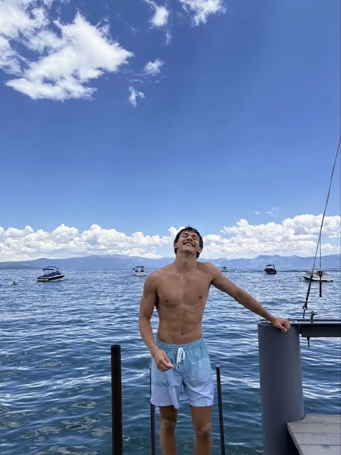 Brennan Harmatz on a dock at a mountain lake