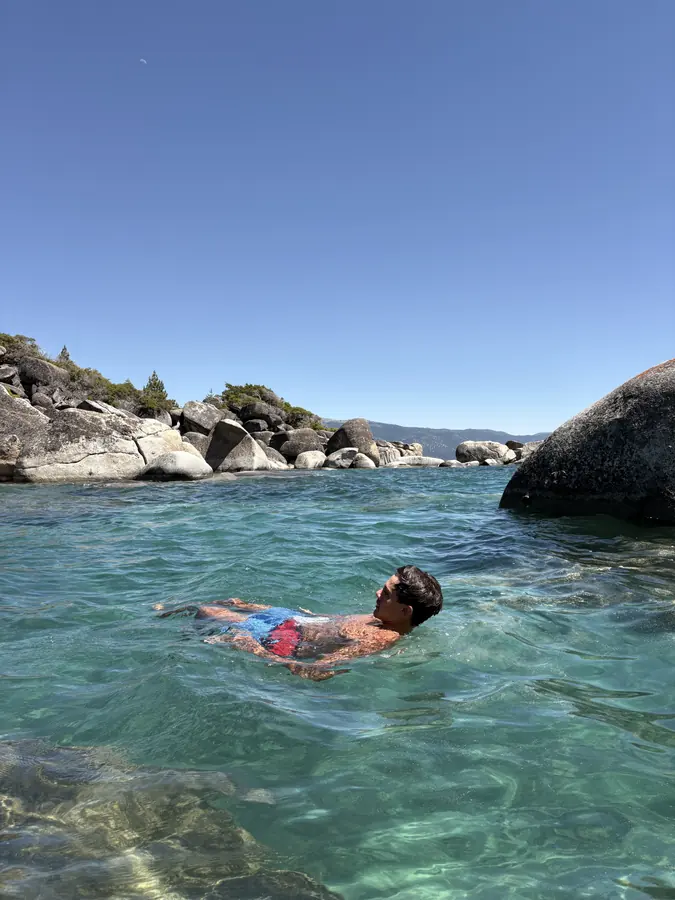 Brennan Harmatz swimming in a clear mountain lake