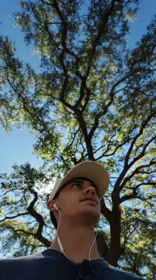 Brennan Harmatz looking up into a tree canopy