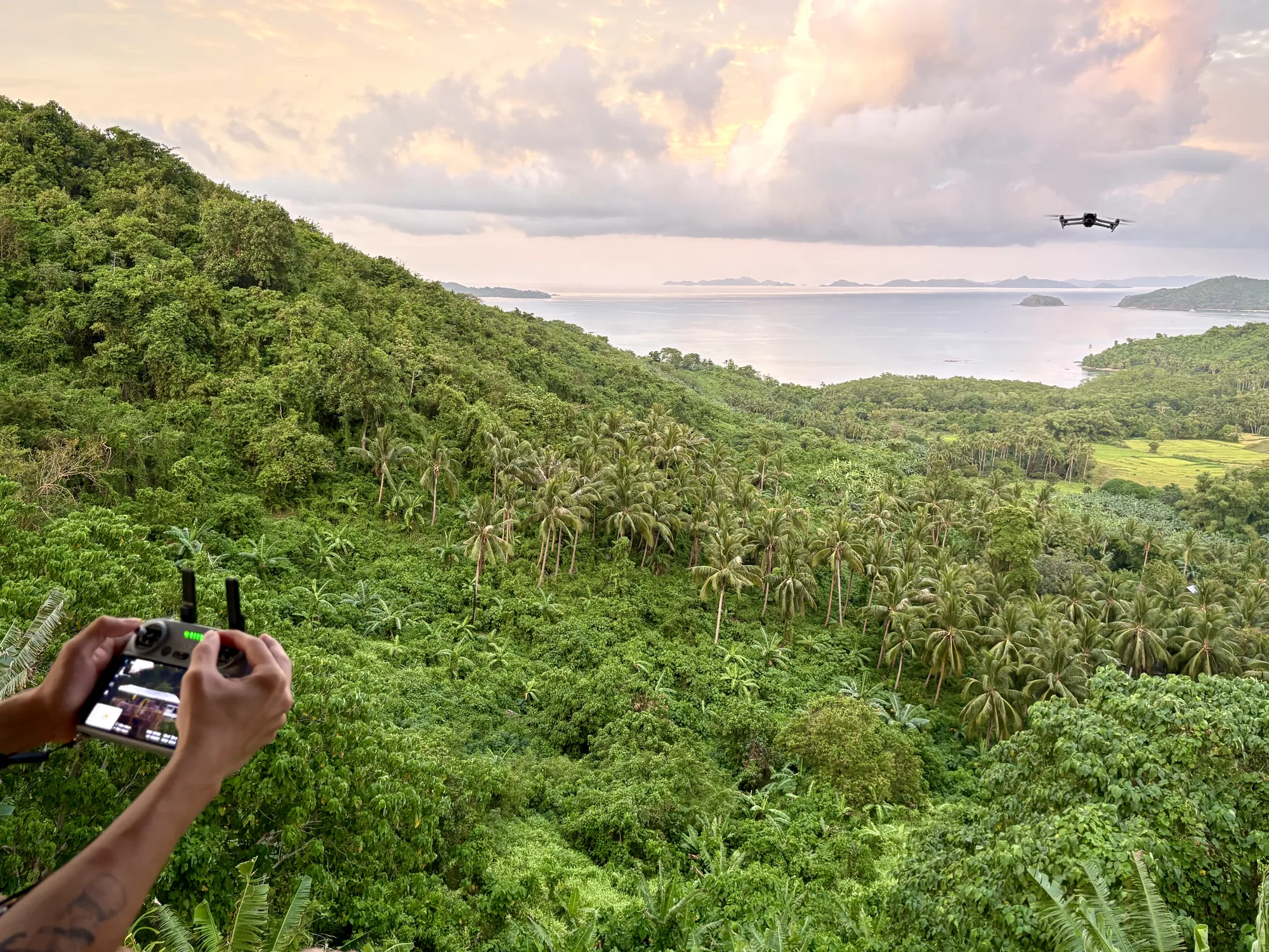 Brennan Harmatz flying a drone over a tropical coastline in the Philippines