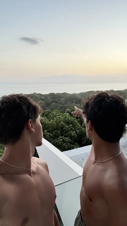 Brennan Harmatz and a friend watching a sunset from a rooftop