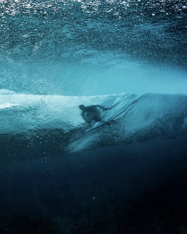 Brennan Harmatz surfing, seen from under the wave