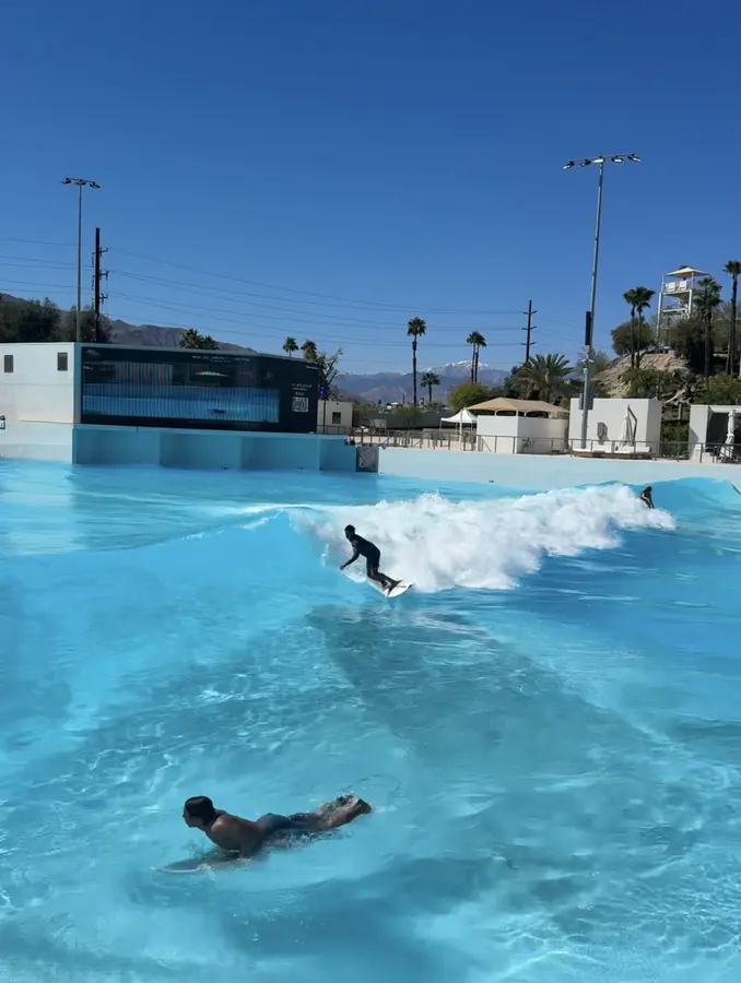 Brennan Harmatz surfing a wave pool at golden hour